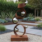 rust sculpture with gazing balls
