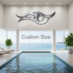 A contemporary indoor swimming pool with large floor-to-ceiling windows showcasing a stunning ocean view. Above the pool, a bold, abstract stainless steel wall sculpture with flowing wave-like curves and a polished, reflective surface is mounted on a light-colored wall. The text “Custom Size” appears in the center of the image, indicating that the sculpture can be made to order. Potted plants and lounge chairs complete the elegant, coastal-inspired design of the space.